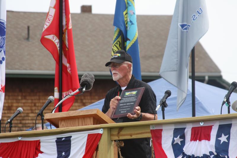 Bob White, a member of the Wareham Veterans Council, accepts a plaque for his efforts in helping to bring The Moving Wall to town. BY MATTHEW BERNAT